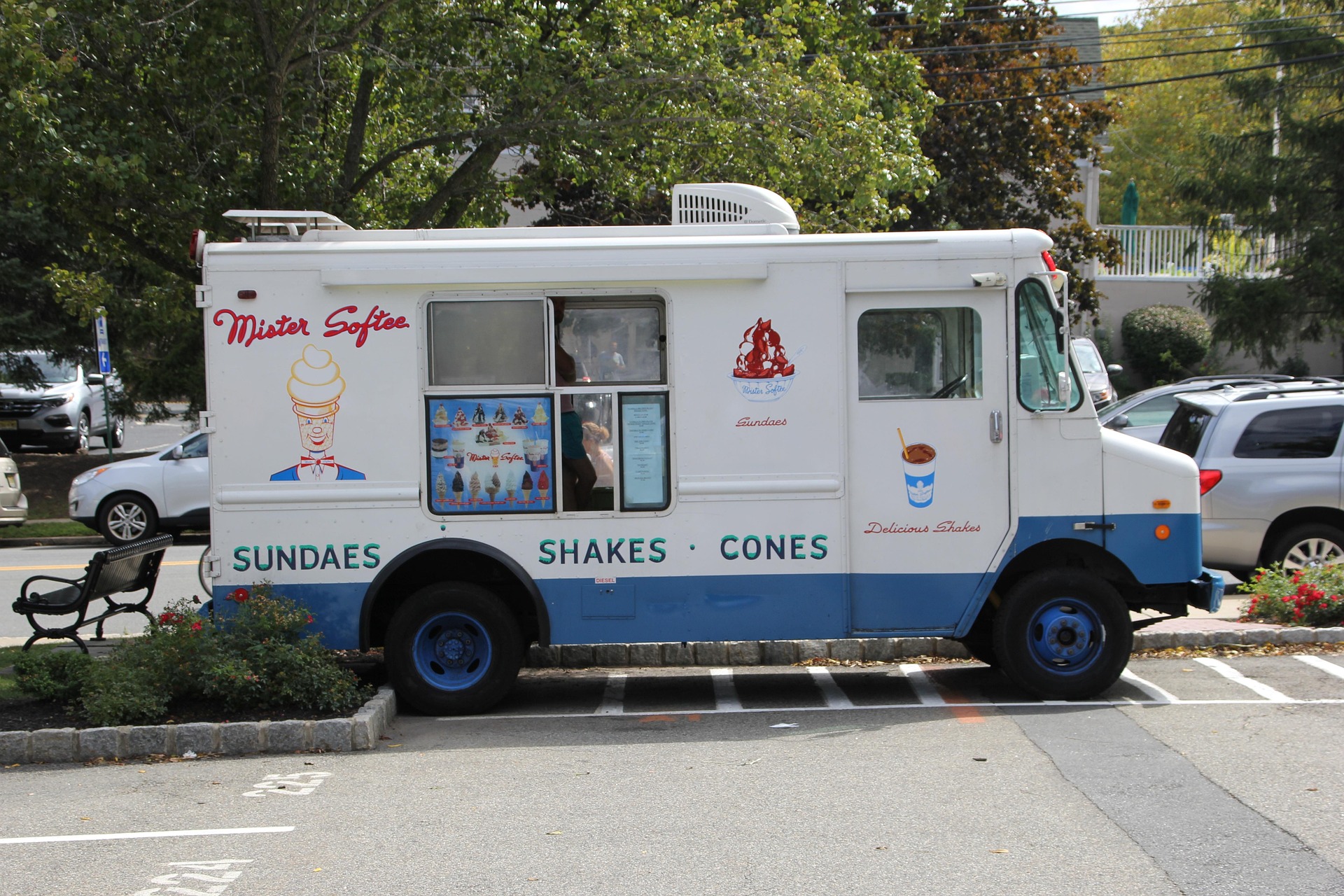 Urban street corner with food truck serving line